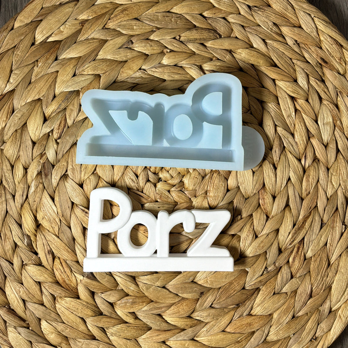 Silikonform für einen Porz-Schriftzug mit Standfläche und weißem Gießling